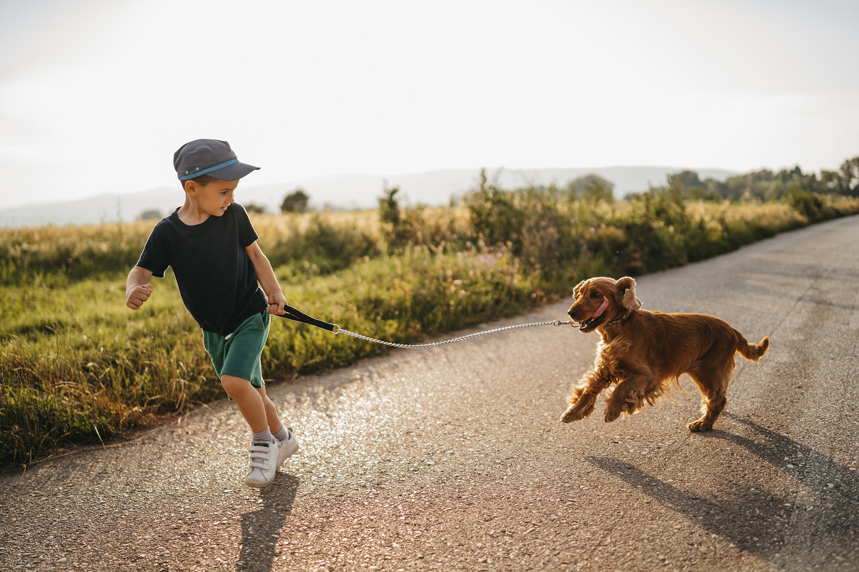 chłopiec biegnący z psem