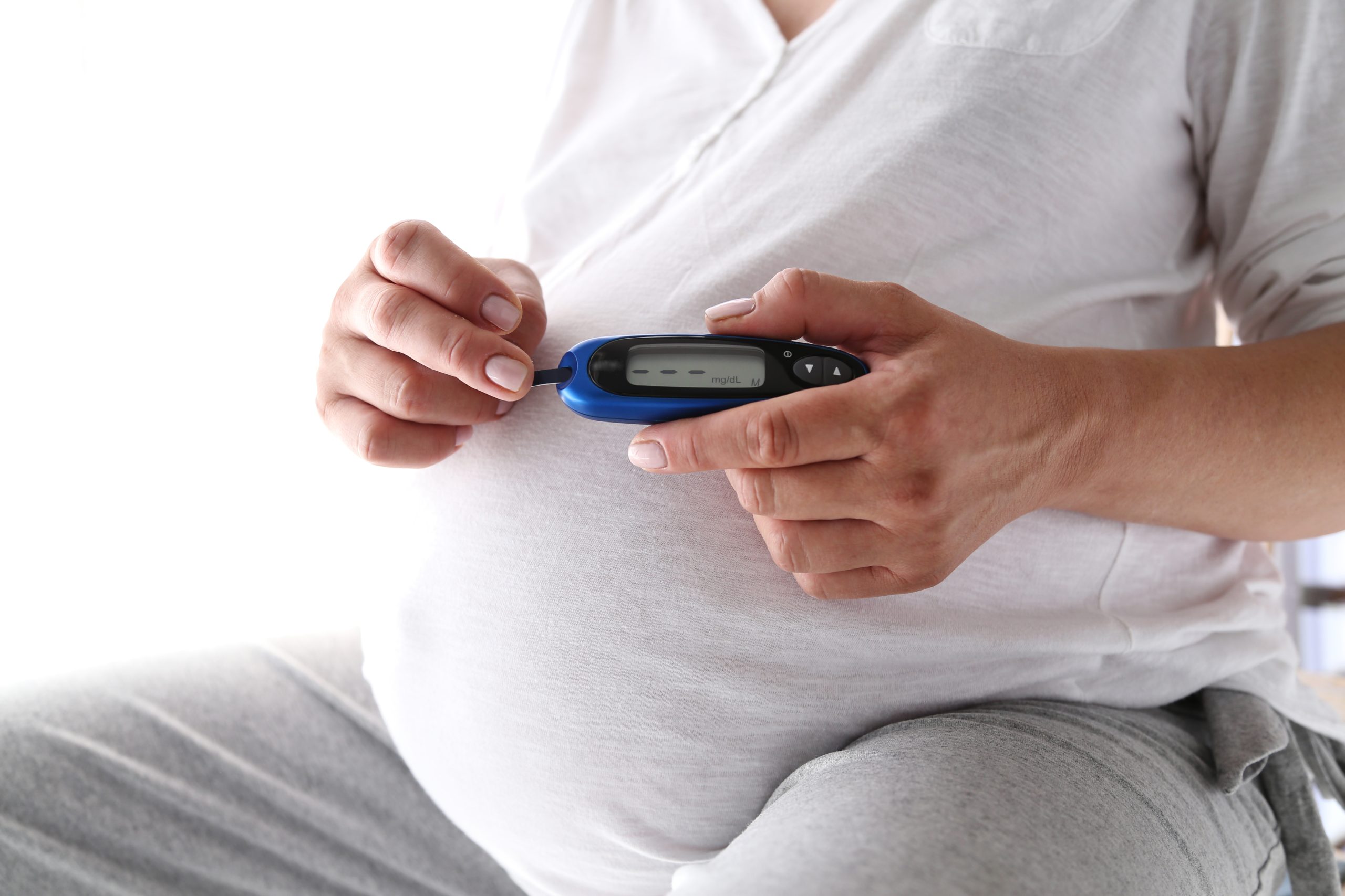 kobieta w ciąży trzymająca glukometr