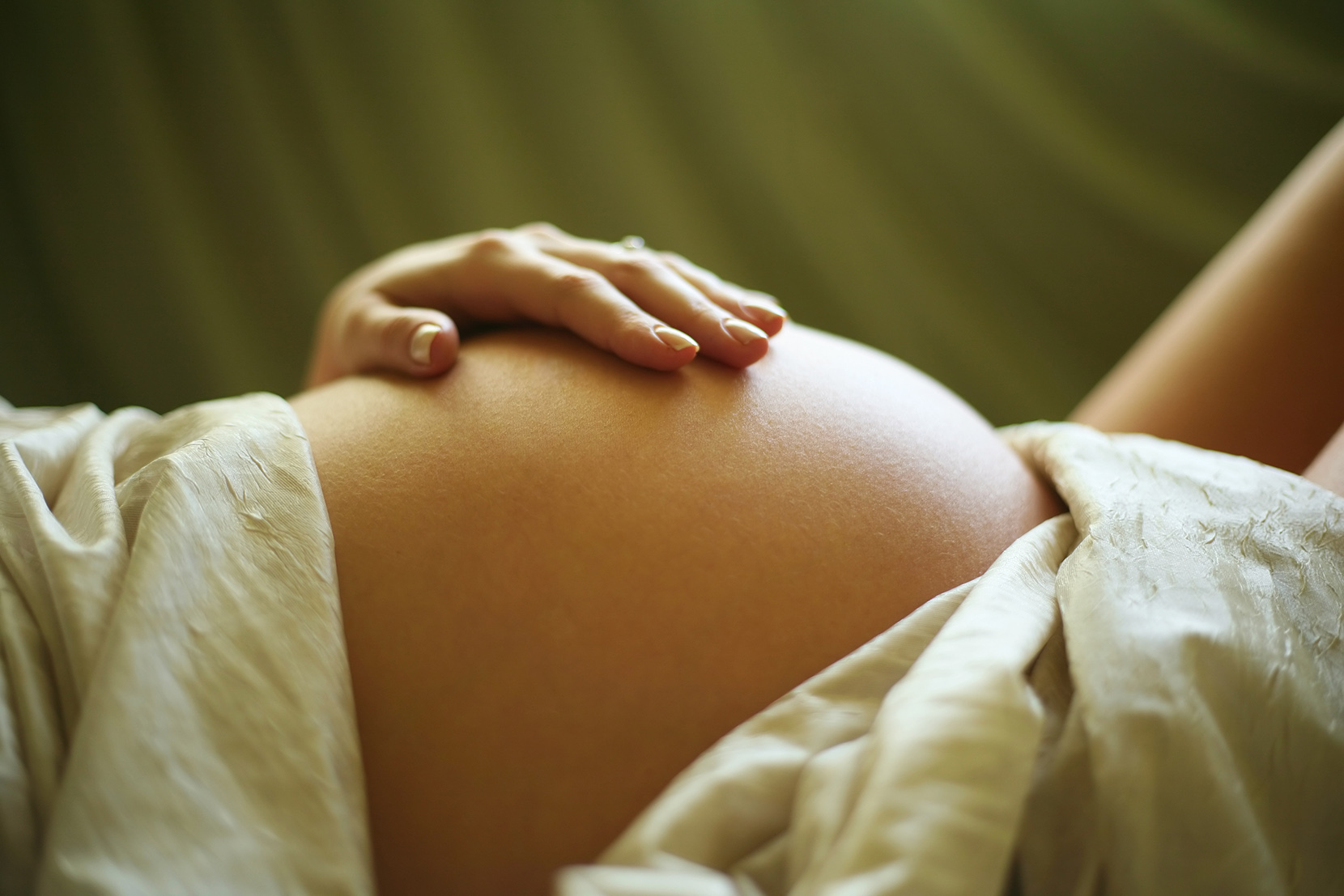 Kobieta w ciąży dotyka się po brzuchu